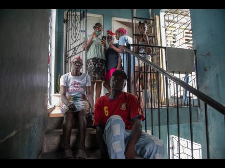 The family of Kerry Ann Collins at their home in in Palm Grove Court, Kingston on Thursday. They are seeking financial assistance to help the 25-year-old burn victim. 
