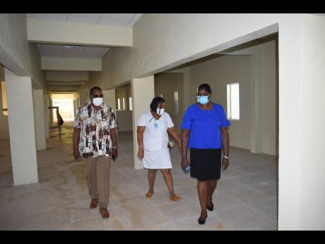 From left: Montego Bay Mayor Leeroy Williams, Matron Jacqueline Wilson and Inspector of Poor Pauline Lecky walk the halls of the soon to be completed ward at the St James Infirmary during a recent tour.
