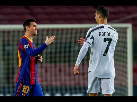 Barcelona’s Lionel Messi (left) shakes hands with Juventus’ Cristiano Ronaldo prior to the start of the Champions League group G match between FC Barcelona and Juventus at the Camp Nou stadium in Barcelona, Spain, yesterday. Juventus won 3-0. 