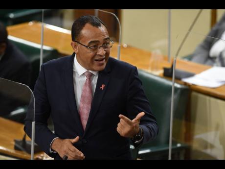 Minister of Health and Wellness Dr Christopher Tufton addressing Parliament about the measures being taken to fight COVID-19 on Tuesday. Jamaica will begin its rollout of coronavirus vaccination in April 2021.