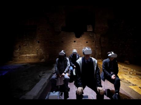 AP
In this Thursday, April 11, 2019 file photo, journalists test virtual reality Oculus as they visit the Domus Transitoria, the first imperial palace of Roman Emperor Nero on the Palatine Hill in Rome, during its opening for the press.