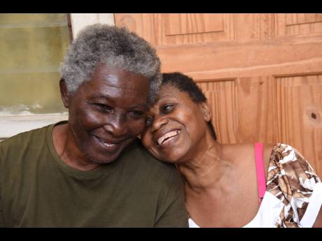 Visually impaired couple Clinton and Lorna Stewart enjoying each other’s company at their rented home in Cockburn Gardens in St Andrew. They are appealing for help to complete their house in Portmore, St Catherine.
