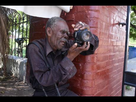 Photographer Lionel Grant has been returning daily to St William Grant Park in downtown Kingston in the hope that his flagging fortunes will change. “It’s the worse Christmas for the period of years that I have been taking pictures,” he lamented.