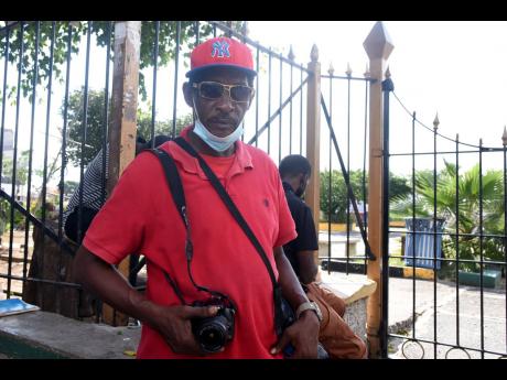 Alan Currie says on some days, he earns as little as $500 for photography services in Mandela Park, Half-Way Tree.