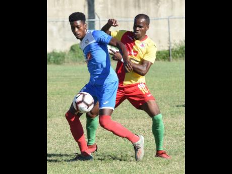 Portmore United’s Shai Smith (left) shields the ball from Humble Lion’s Levaughn Williams during their Jamaica Premier League match at the Spanish Town Prison Oval in St Catherine on Sunday, January 5.