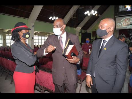 Giving thanks in COVID times: The Customs Brokers and Freight Forwarders Association of Jamaica (CBFFAJ) recently commemorated its 55th anniversary at the Kingston Open Bible Church, where CBFFAJ member Lorencia Long is caught greeting elder Donald Cruicks