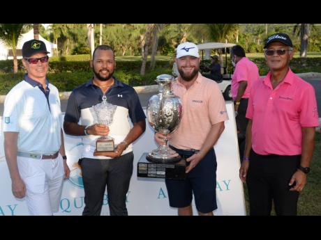 From left: Scott Summy, representing sponsors Aqua Bay Villas, poses with amateur winner William Knibbs, pro winner Erik Barnes and President of the Jamaica Golf Association, Peter Chin, during the presentation ceremony of the Jamaica Open tournament, whic