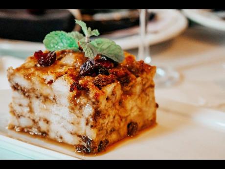 There’s nothing more heavenly than a warm slice of holiday bread pudding with rum-soaked raisins, dried cranberries and caramel sauce.