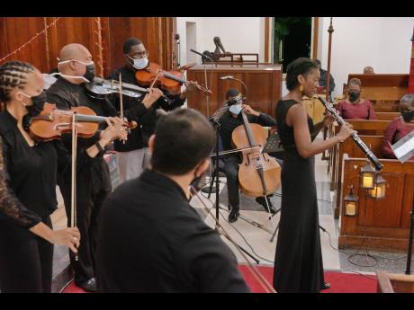 Oboist Dr Althea Neblett performs with the Philharmonic Orchestra of Jamaica.