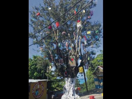Daytime view of the Oracabessa Christmas tree with its brightly coloured handmade ornaments brightening the town centre.  