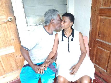 Elderly blind couple Clinton and Lorna Stewart share a kiss at their current rented premises in Cockburn Gardens, St Andrew.