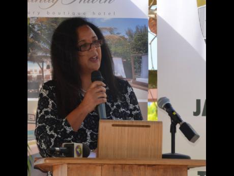 JHTA Negril chapter chair Ann Chen addresses a ceremony for the COVID-19 Ambassadors Programme at the Sandy Haven Resort recently.