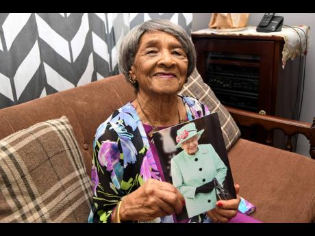 Elsie Smikle shows off a congratulatory card she received from the Queen last year as she ­celebrated her 100th­ ­birthday.