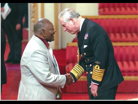 Norman Mitchell receiving his MBE from Prince Charles.