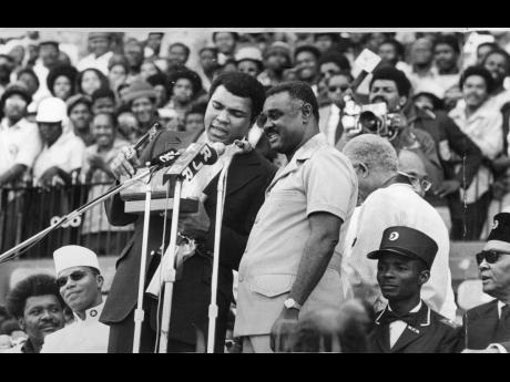 World heavyweight boxing champion Muhammad Ali (left) saying thanks as he holds the Key to the City of Kingston. The Key symbolizes freedom of the city and was presented to him on December 29 by the Mayor of Kingston, Councillor Ralph Brown, at the grand r