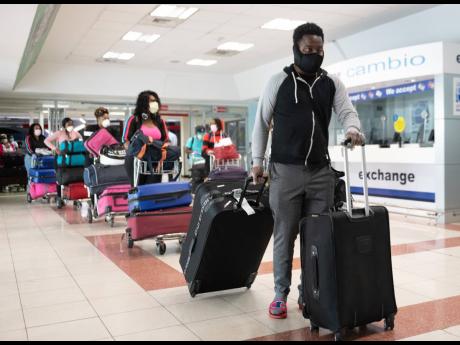 
Some of the more than 200 Jamaicans arriving at the Norman Manley International Airport in Kingston on May 13, 2020 as the country’s borders were partially reopened to allow citizens to return to the island amid the COVID-19 pandemic.