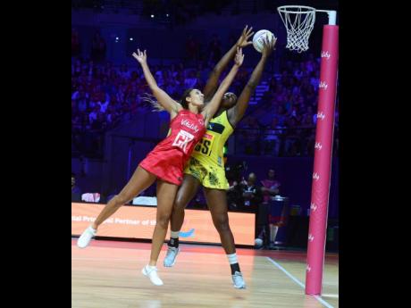 
Sunshine Girls captain Jhaniele Fowler (right) outstretches England Roses goal keeper Geva Mentor to claim the ball, before scoring a goal during their Group G Vitality Netball World Cup match in Liverpool, England, on July 15, 2019. 