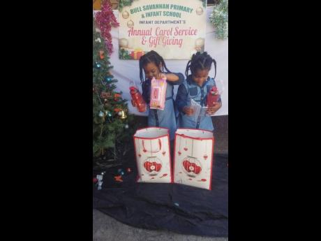 Twins discover their gifts at the annual carol service and gift giving ceremony for children at Bull Savannah Primary and Infant School.
