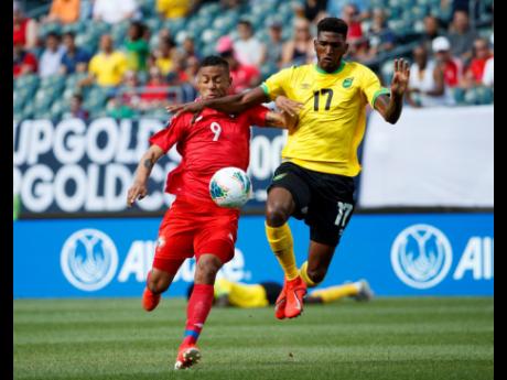 Jamaica’s Damion Lowe (right) and Panama’s Gabriel Torres battle for the ball during the first half of a Concacaf Gold Cup match in Philadelphia last year.  Jamaica won 1-0. 