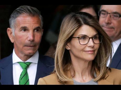 Actress Lori Loughlin and husband, clothing designer Mossimo Giannulli (left). Loughlin was released from federal prison in Dublin, California, on Monday. 