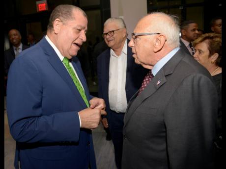 Then Minister of Industry, Commerce, Agriculture and Fisheries Audley Shaw (left) speaking with US ambassador to Jamaica, Donald Tapia, at a reception at the AC Hotel in Kingston on October 23, 2019. In background is Karl Samuda.