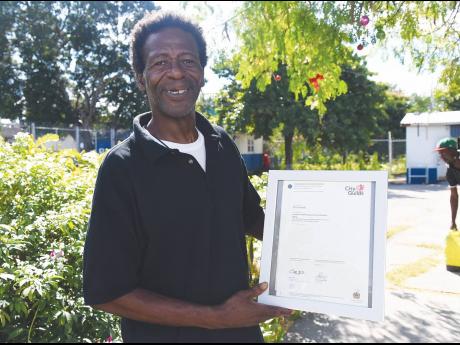 Devon Wade, a resident of the Open Arms Drop-in Centre, proudly shows off his City and Guilds skills certificate.