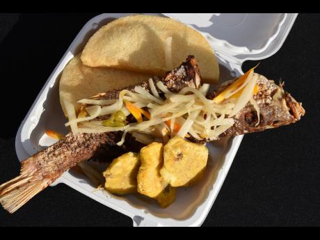 The escoveitched red snapper is served with a side of bammy and pressed plantains. 