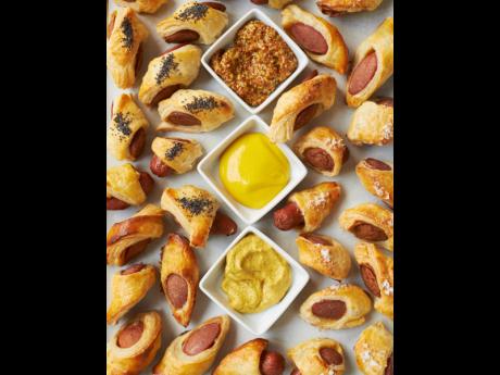 Pigs in blankets with mustard sauces is a popular hors d’oeuvre. 