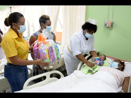 Top right: Lison Burke welcomed her baby into the world on New Year’s Day at the Spanish Town Hospital in St Catherine. Minister of State in the Ministry of Health and Wellness, Juliet Cuthbert-Flynn (second left), paid a visit to congratulate her. Also 