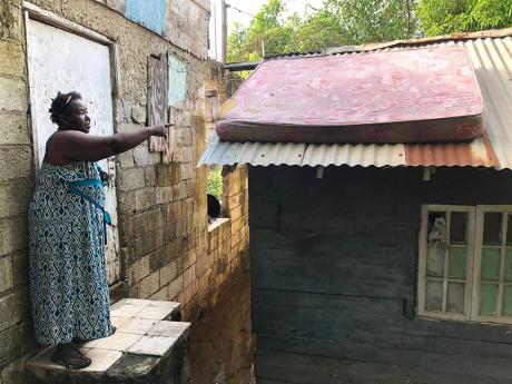 Yvonne Sterling was discovered by our reporter sun-drying her mattress atop the roof of her flooded home on Riverside Drive in New Haven, St Andrew.