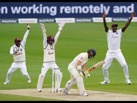 West Indies players appeal successfully for the wicket of England’s Rory Burns (second right) during the first day of their second Test match at Old Trafford in Manchester, England, on Thursday, July 16, 2020.