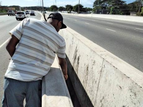 Richard Goodall points to the opening he fell through along a section of the Mandela Highway in St Catherine, on the night of December 15, 2020. He sustained minor injuries in the incident.