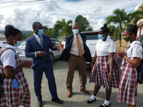 President of the Jamaica Teachers’ Association Jasford Gabriel (second left) and South East Regional Officer Basil Benjie engage students of the Paul Bogle High School in St Thomas during a tour of institutions in the parish that have resumed face-to-fac