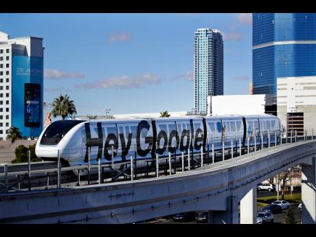 In this January 10, 2018, file photo, a monorail with a Google advertisement passes the Las Vegas Convention Center during CES International in Las Vegas. 