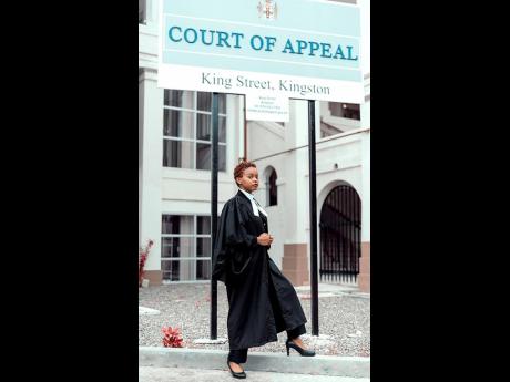 Montegonian Caleigh Reid poses outside of the Court of Appeal in Kingston shortly after passing the Bar recently.