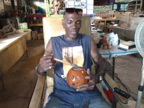 Garfield Williams says the switched from importing white clay to using local clay to create his pieces has been paying off.