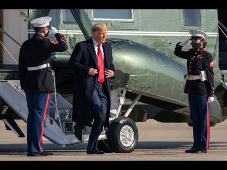 President Donald Trump disembarks from Marine One to board Air Force One at Andrews Air Force Base, Maryland, for a trip to Alamo, Texas, yesterday.