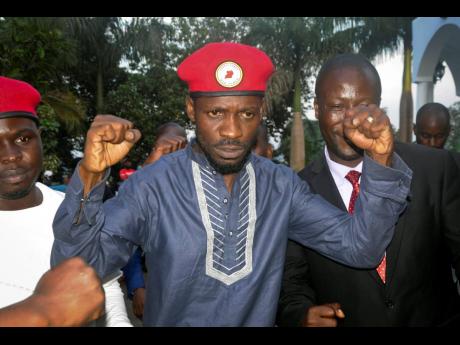 Ugandan pop star and opposition figure Bobi Wine greets his followers as he arrives home after being released from prison on bail in Kampala, Uganda, Thursday, May 2, 2019. Wine was freed on bail Thursday after spending three nights in a maximum-security p