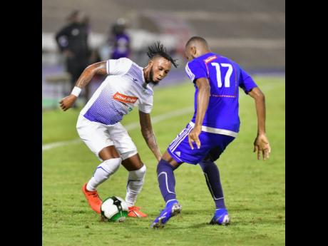 Portmore United’s Roshane Sharpe (left) goes on the offensive against Mount Pleasant’s Rodney Ranaldo in the Red Stripe Premier League semi-final at the The National Stadium on Monday April 15, 2019.