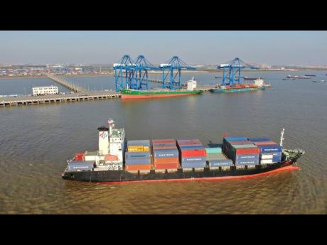 AP 
A container ship leaves a port in Nantong, in eastern China’s Jiangsu Province, on December 20, 2020. 
