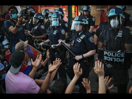  This May 31, 2020 file photo shows New York City Police facing off with activists during a protest march in the Bedford-Stuyvesant section of the Brooklyn borough of New York. 
