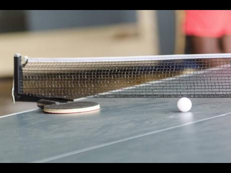 Table tennis racket and ball.