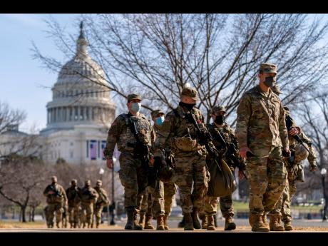 Members of the National Guard patrol outside the Capitol Building on Capitol Hill in Washington yesterday.