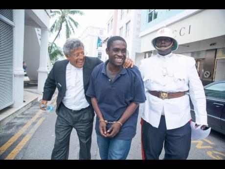In this 2015 photo, Matthew Sewell (centre) and his lawyer Fred Smith QC (left) are heading to the Bahamian Supreme Court in Nassau. Sewell is escorted by a Bahamian policeman.