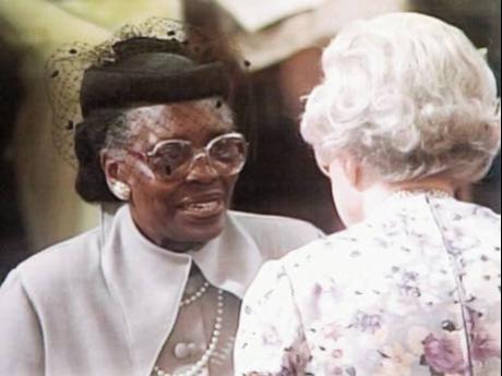 Eunice McGhie-Belgrave receives the  MBE award from the Queen in 2002.