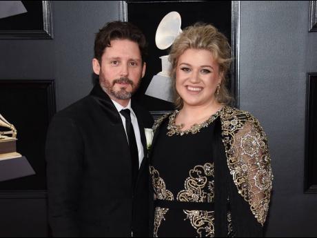  In this January 28, 2018 file photo shows Kelly Clarkson and her husband Brandon Blackstock at the 60th annual Grammy Awards in New York. Clarkson has filed for divorce from her husband of nearly seven years. The singer, talk show host and judge filed cou