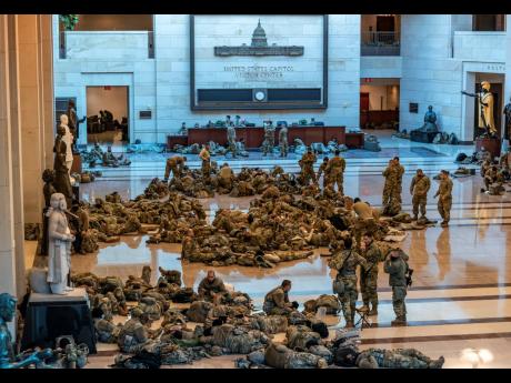 
Hundreds of National Guard troops hold inside the Capitol Visitor’s Center to reinforce security at the Capitol in Washington, Wednesday, January 13, 2021. The House of Representatives pursued an article of impeachment against President Donald Trump for