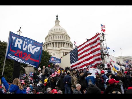 In this January 6, 2021, file photo, supporters of President Donald Trump stand outside the US Capitol in Washington. Black activists are coming out strongly against a growing narrative among conservatives that equates the deadly siege on the US Capitol to