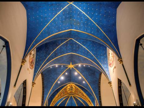 Nearly 5,000 stars are painted on the blue ceiling of the sanctuary at St. Mark’s Catholic Church in Peoria, Ill. Peoria artist Andrew Hattermann and the artists of Murals by Jericho have built a successful business painting and beautifying churches all 