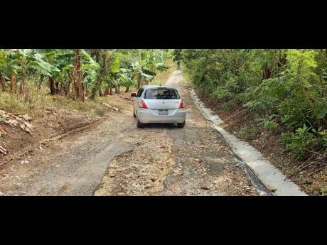 A section of the road in Marlie, St Mary, which is in urgent need of repair. Member of parliament Robert Montague has assured the rersidents that he is addressing the problem and also promised to provide pipe water to the communitiy. 